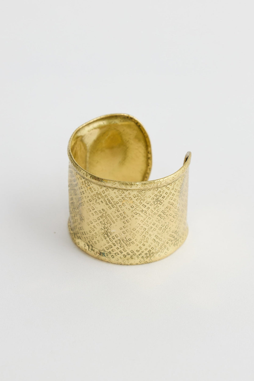Gold textured cuff on a light gray background