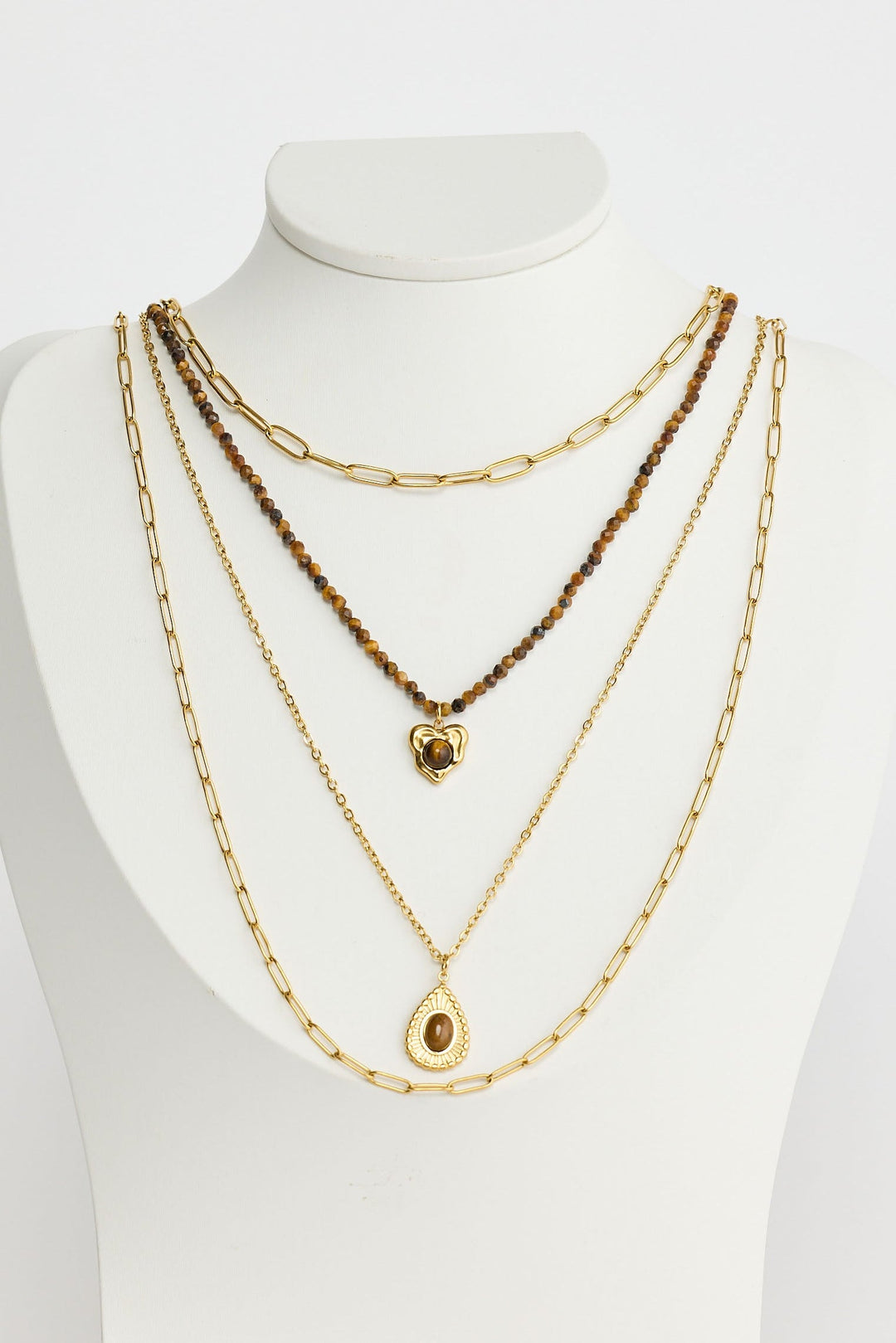 Close-up of gold alex necklace necklace on white background.