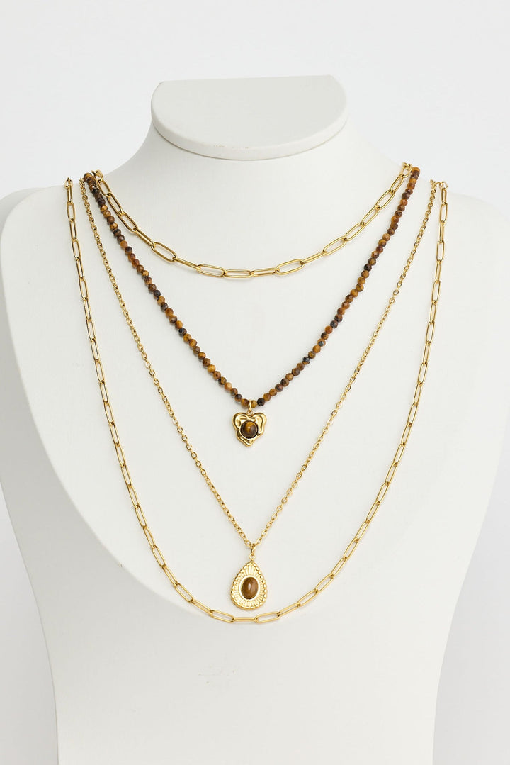 Close-up of gold alex necklace necklace on white background.