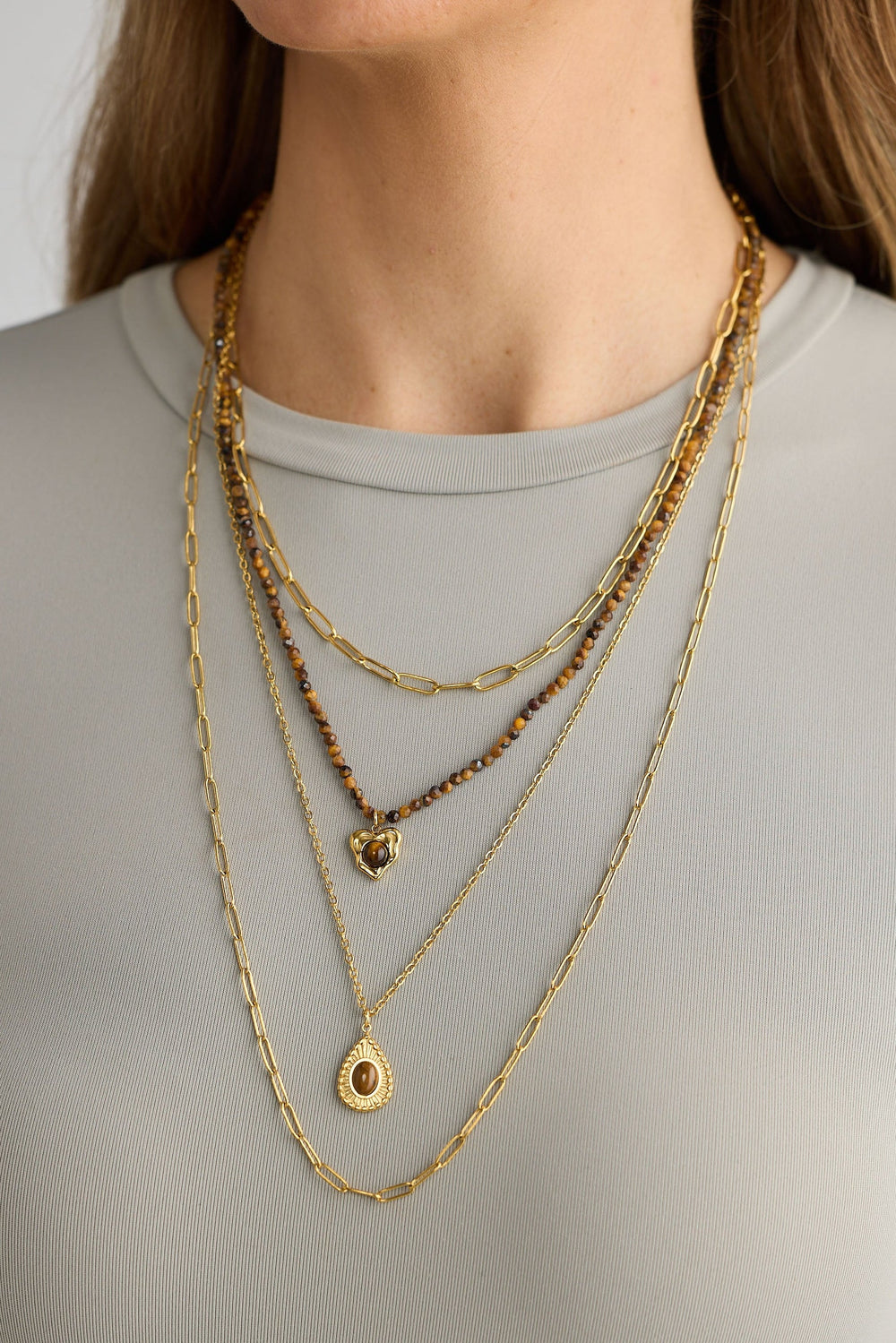 Close-up of gold alex necklace necklace on white background.