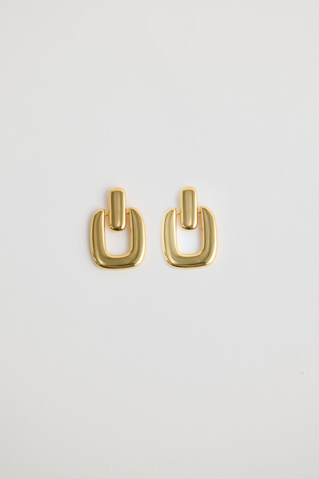 Close-up of gold avery earrings earrings on white background.
