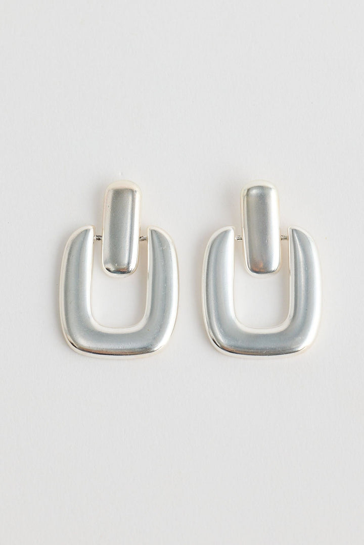 Close-up of silver avery earrings earrings on white background.