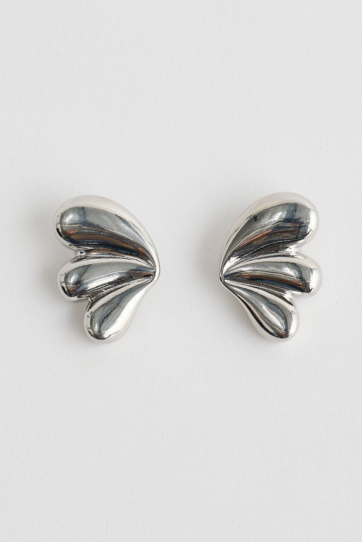 Close-up of silver taylor earrings earrings on white background.