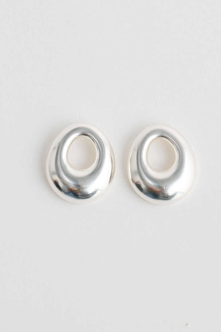 Close-up of silver jordan earrings earrings on white background.
