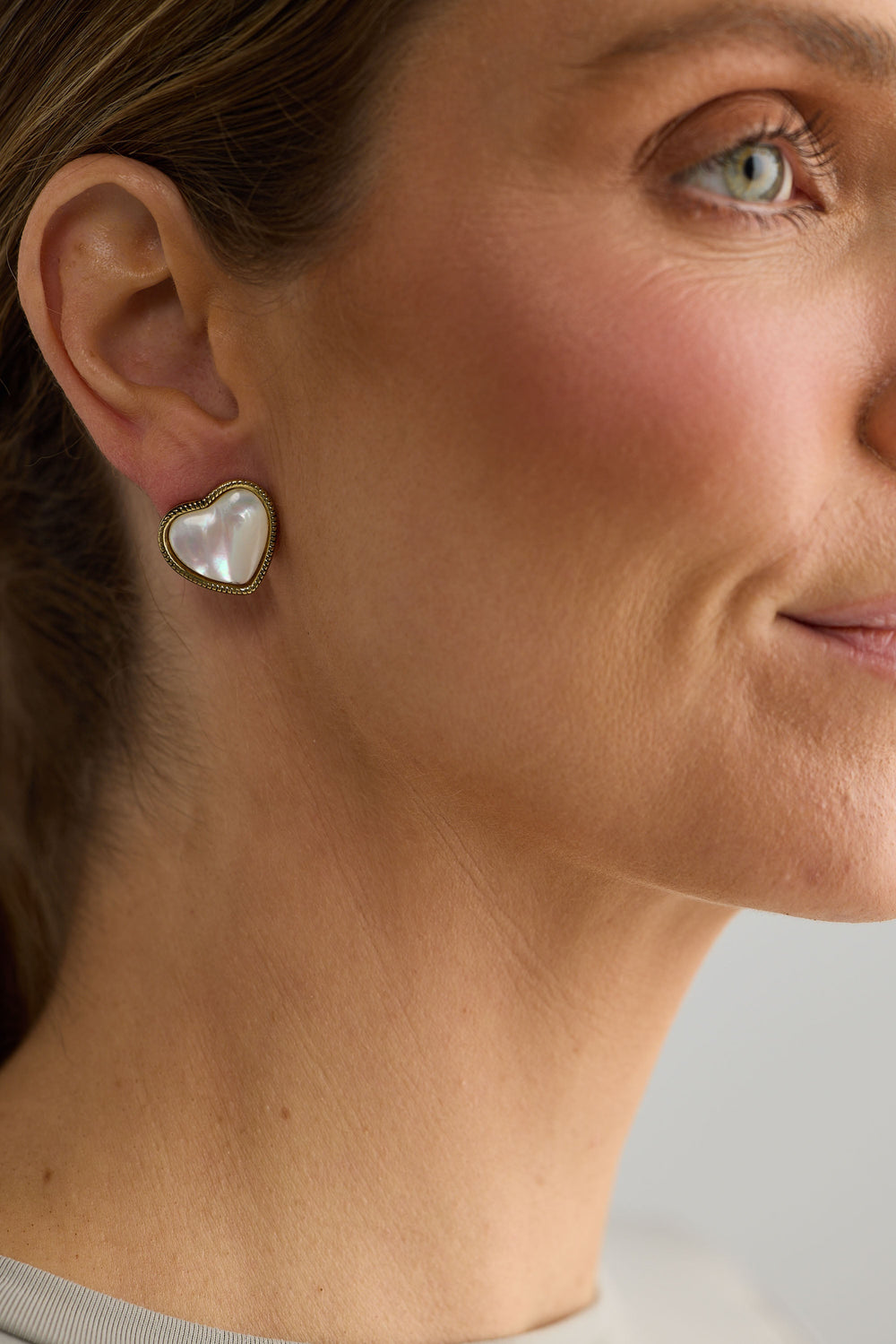 Close-up of white finley earrings earrings on white background.