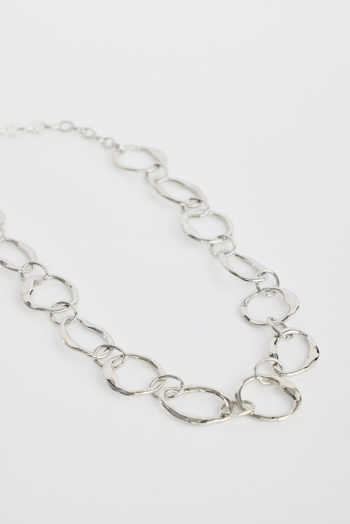 Close-up of silver hemsworth necklace necklace on white background.