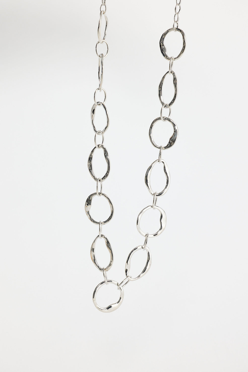 Close-up of silver hemsworth necklace necklace on white background.