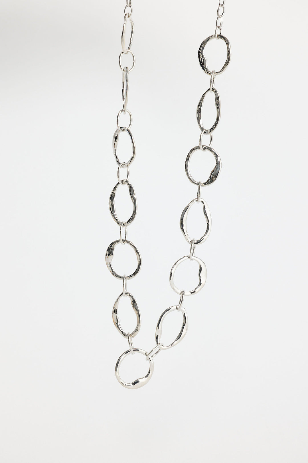 Close-up of silver hemsworth necklace necklace on white background.