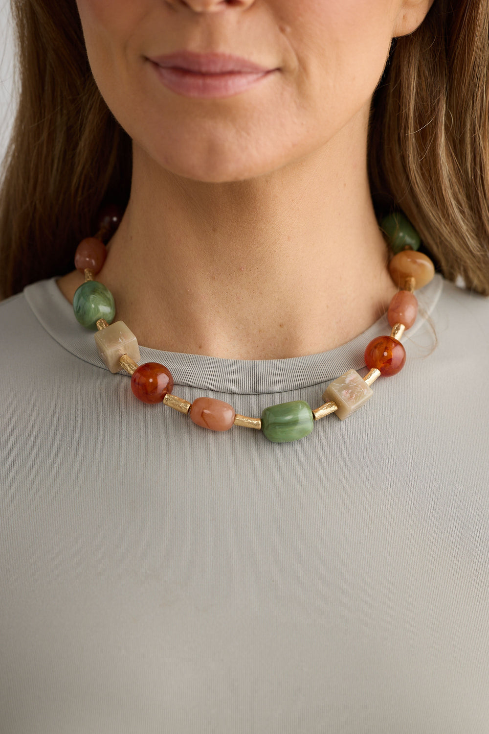 Close-up of sage autumn necklace necklace on white background.