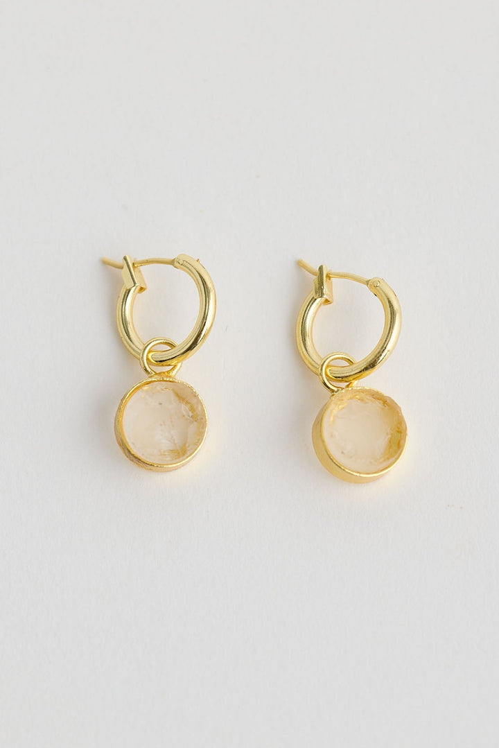 Close-up of amber carey earrings earrings on white background.