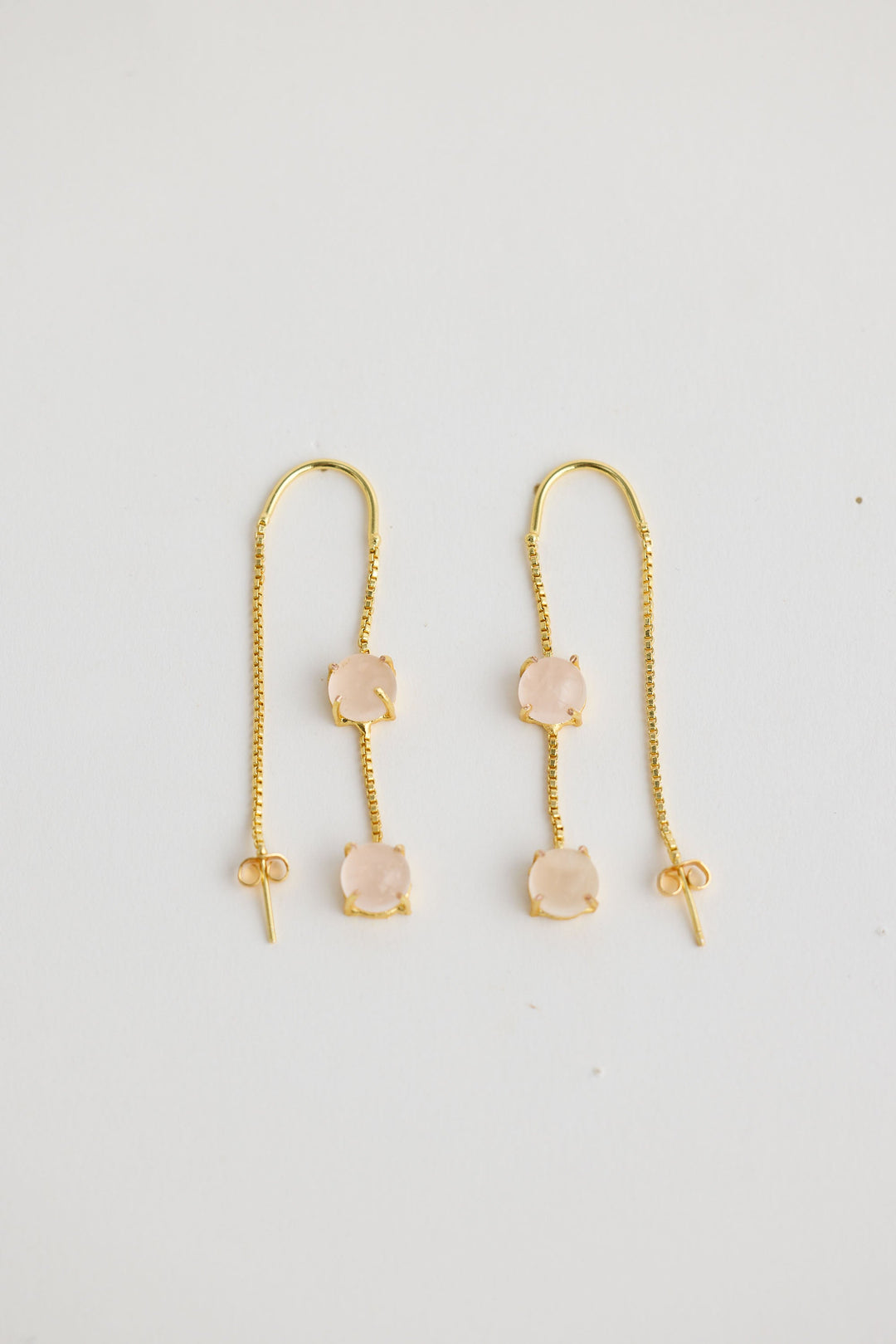 Close-up of white houston earrings earrings on white background.