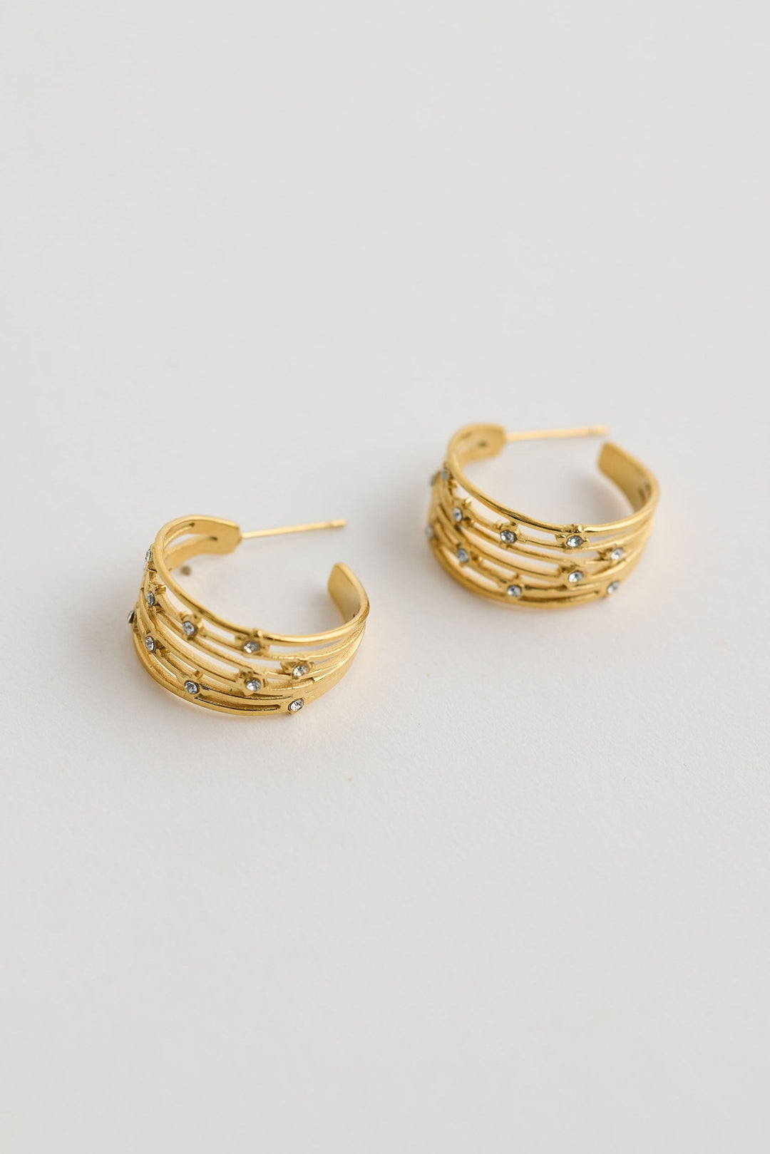 Close-up of clear ava earrings earrings on white background.