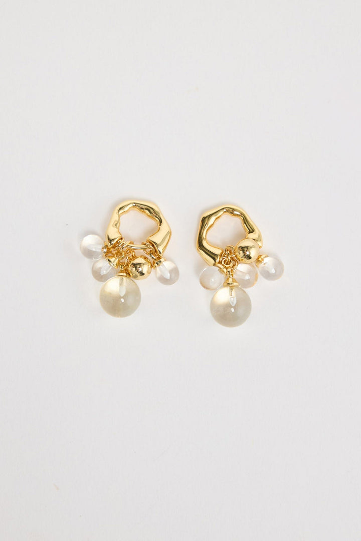 Bubble Earrings in Gold – gold-tone organic hoop earrings with a cluster of clear glass bubble beads, shown flat on a white background.