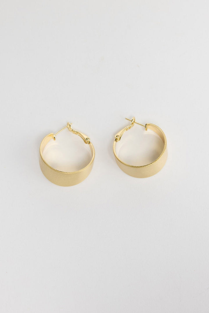 Siren Earrings in Gold, alternate angle showing the width and satin finish of the gold hoop.
