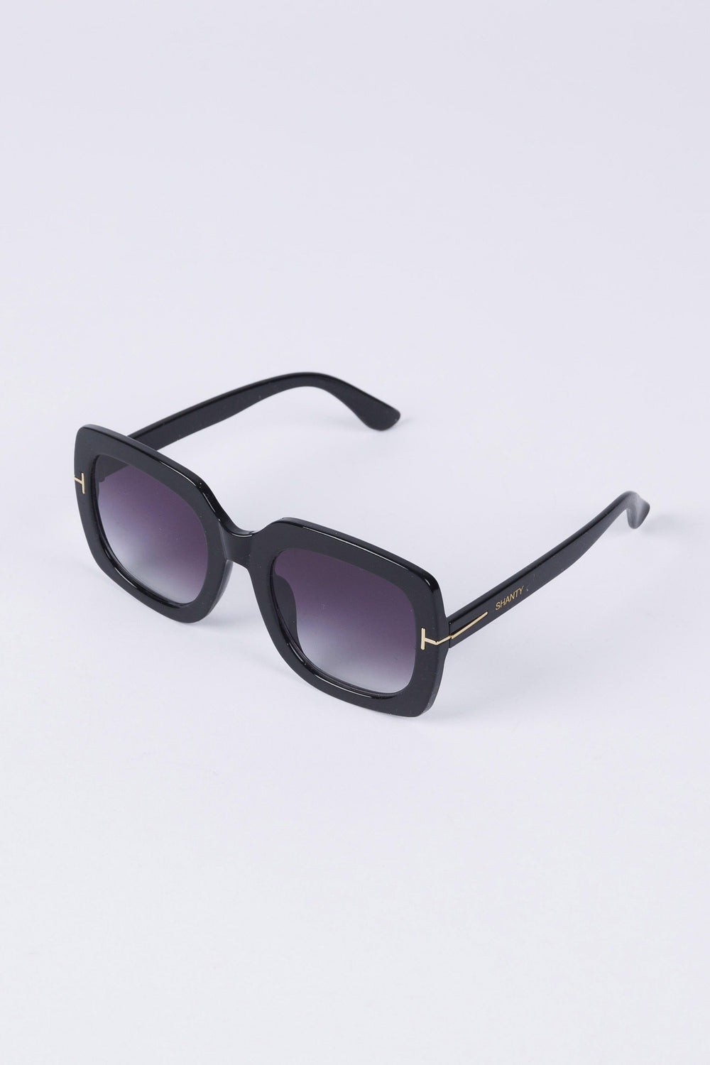 Black sunglasses on a light purple background