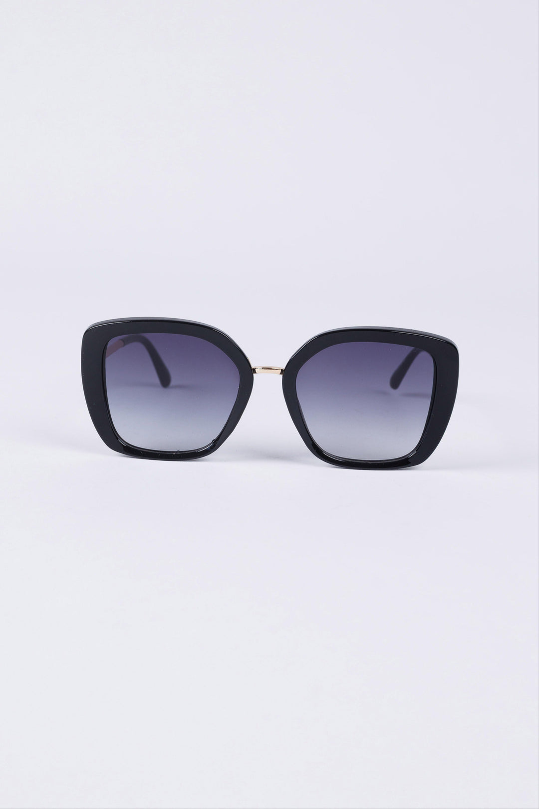 Black cat-eye sunglasses with gradient lenses on a light purple background