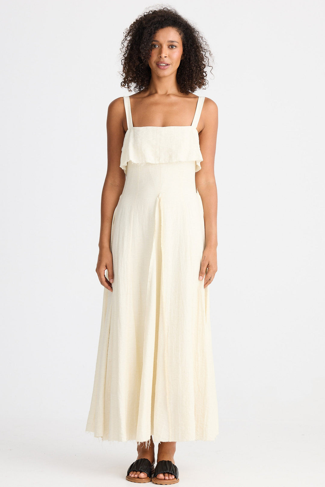 Woman wearing a cream dress on a white background