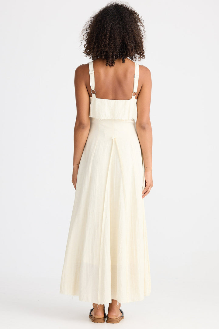 Woman wearing a cream dress on a white background