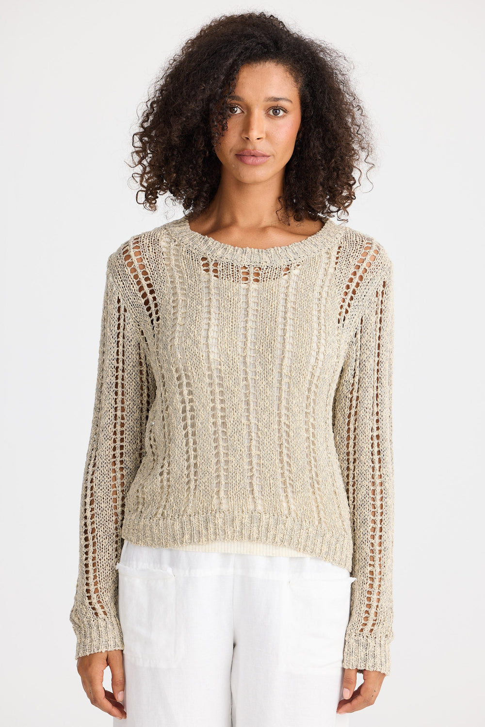 Woman wearing a beige knitted sweater on a white background