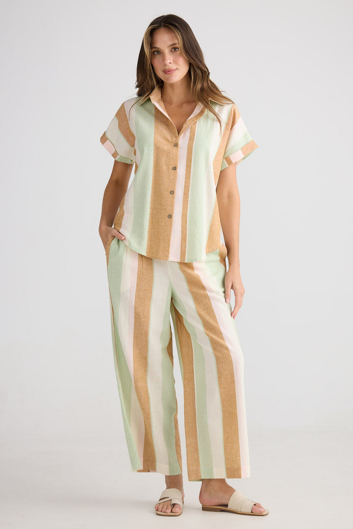 Woman wearing a striped outfit on a white background