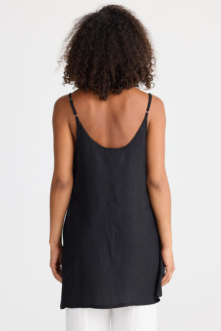 Person wearing a black sleeveless top on a white background
