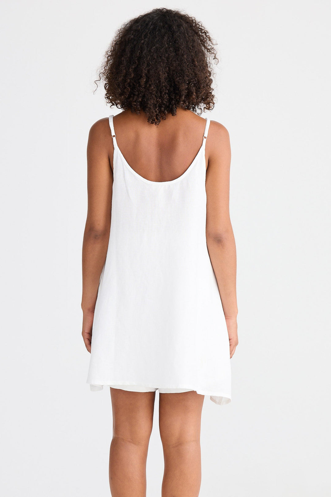 Woman wearing a white singlet on a white background