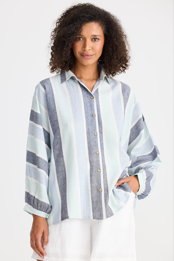 Woman wearing a striped shirt with a white background