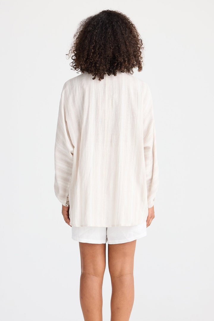 Person wearing a light coloured striped shirt and shorts on a white background