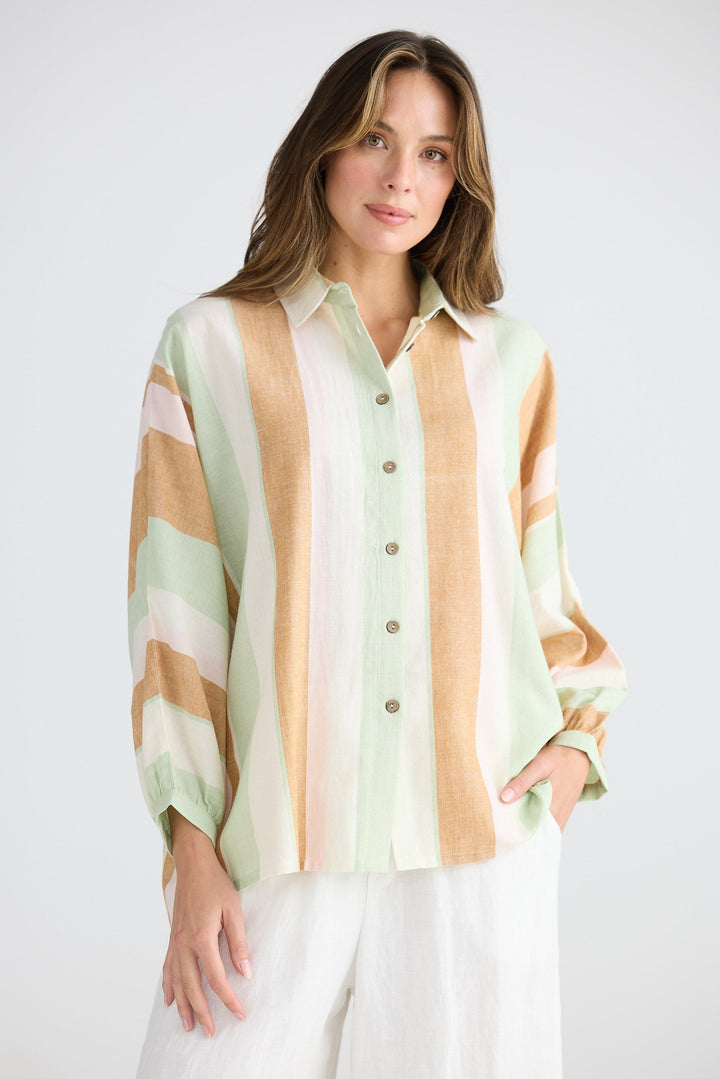 Woman wearing a striped shirt with a plain background