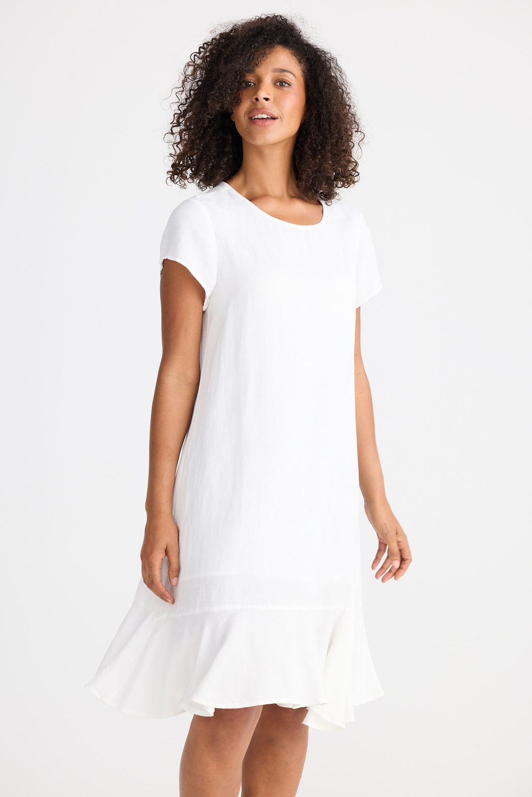 Woman wearing a white dress against a plain background
