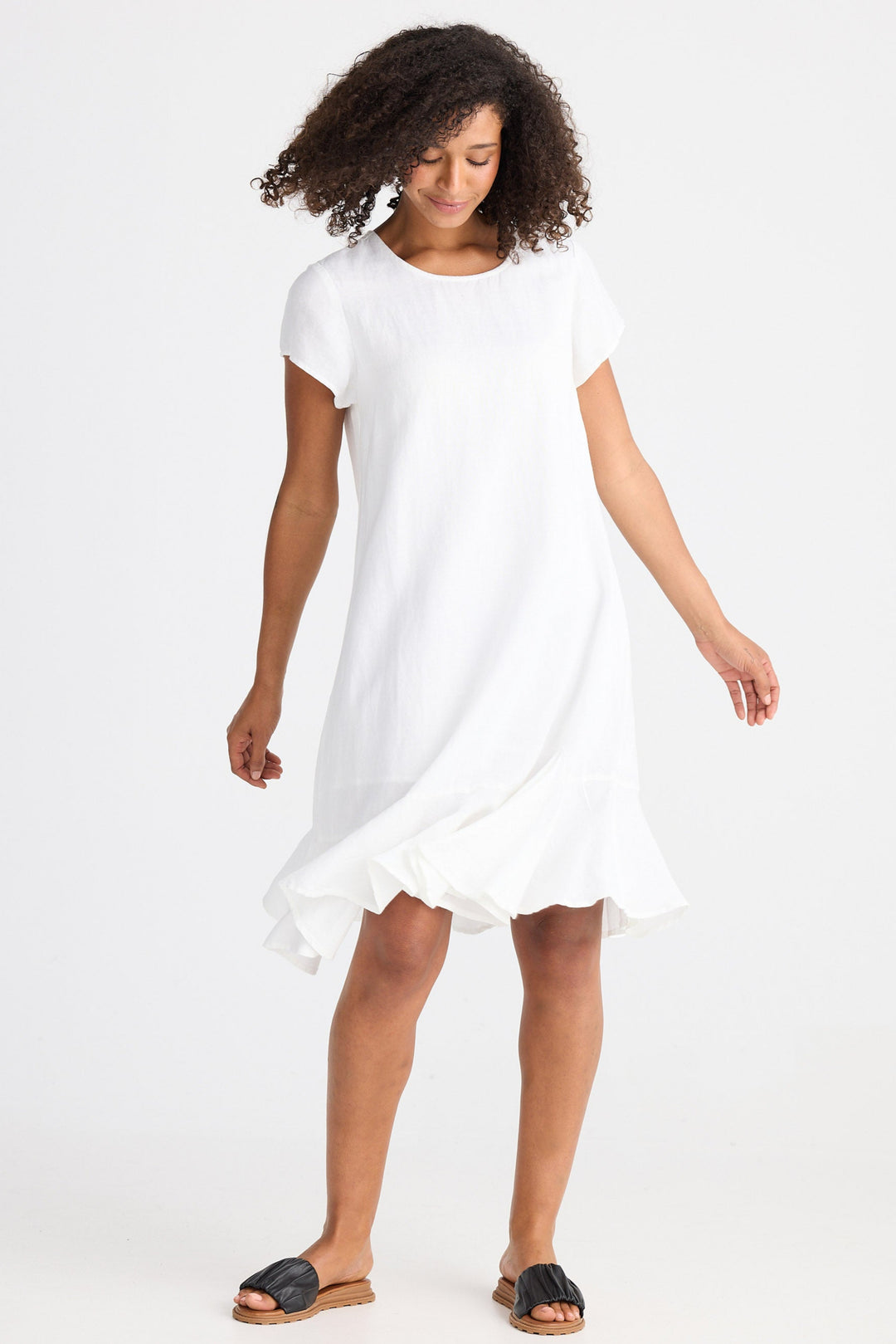 Woman wearing a white dress on a plain background
