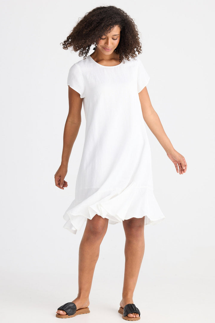 Woman wearing a white dress on a plain background