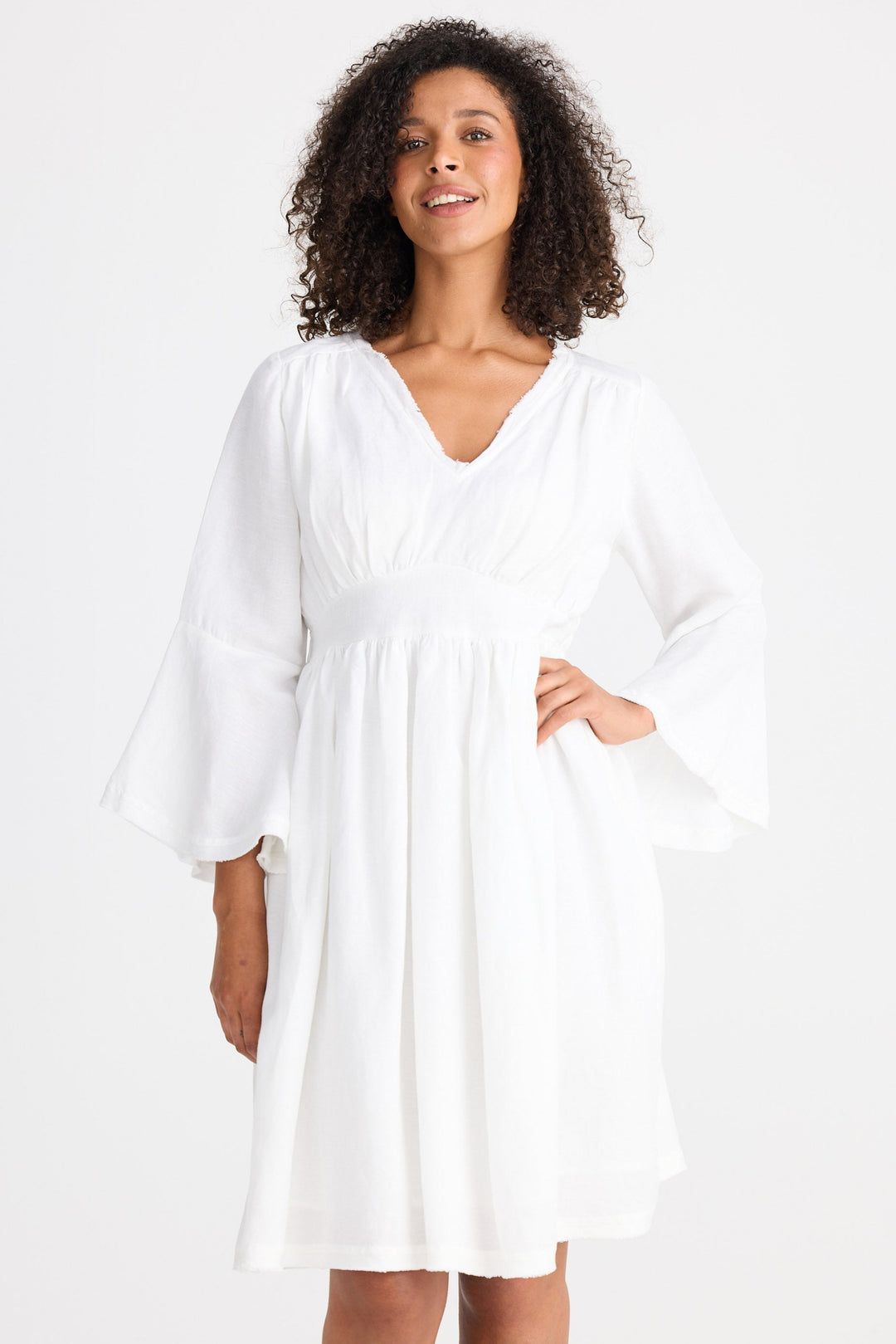 Woman wearing a white dress against a white background