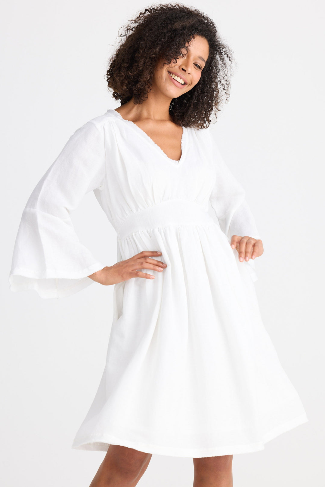 Woman wearing a white dress against a white background