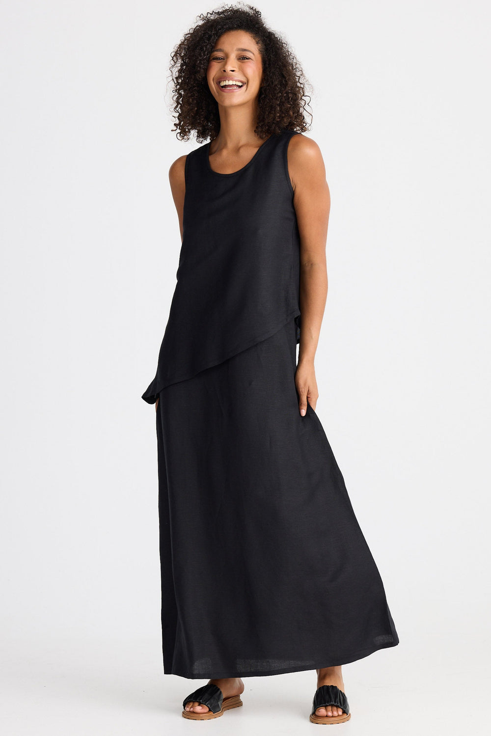 Woman wearing a black sleeveless dress on a white background