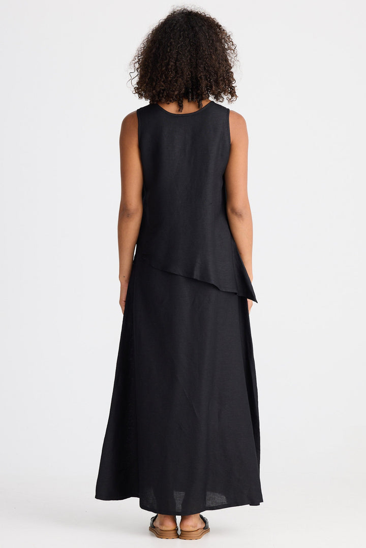 Person wearing a black sleeveless dress on a white background