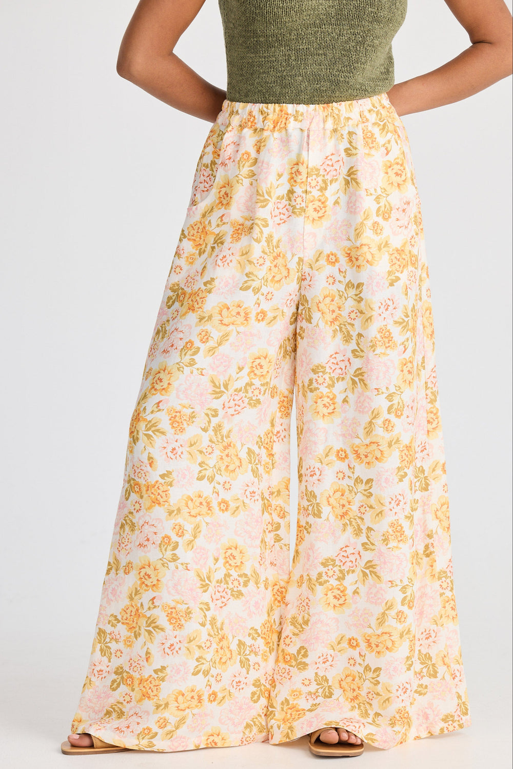 Person wearing a floral skirt with a plain background