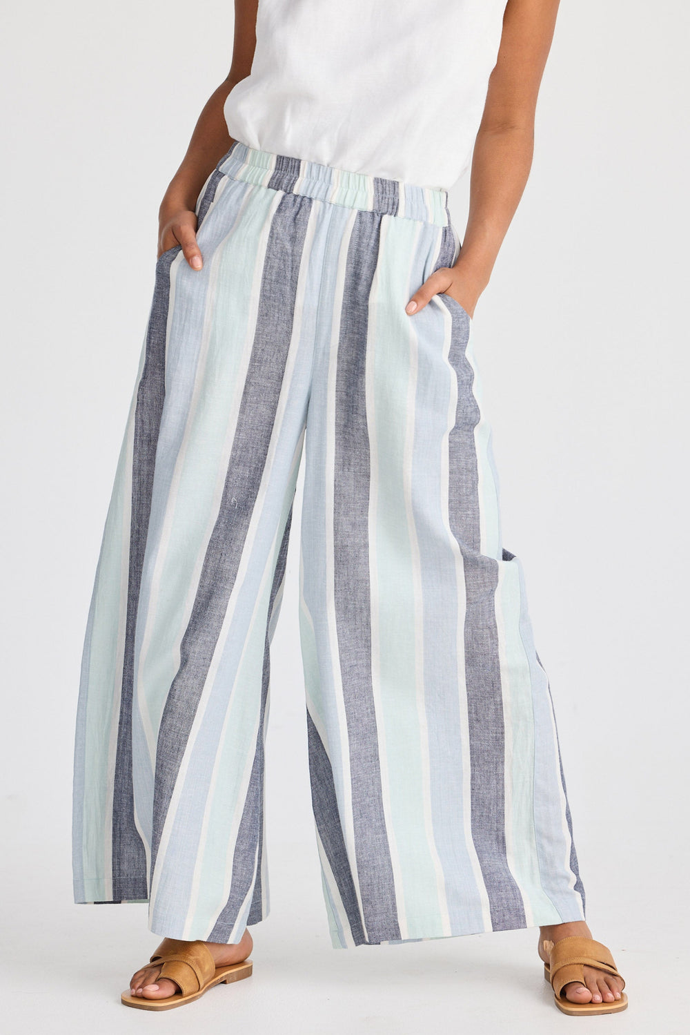 Person wearing striped wide-leg pants on a white background