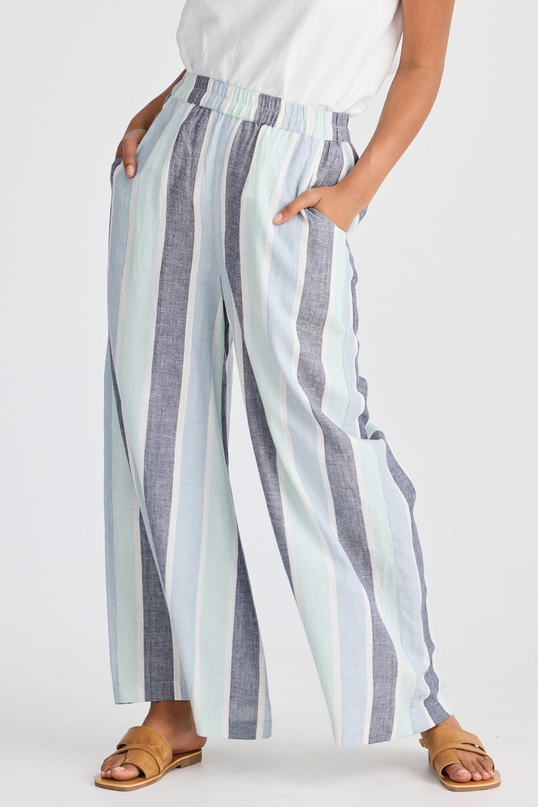 Person wearing striped wide-leg pants on a white background