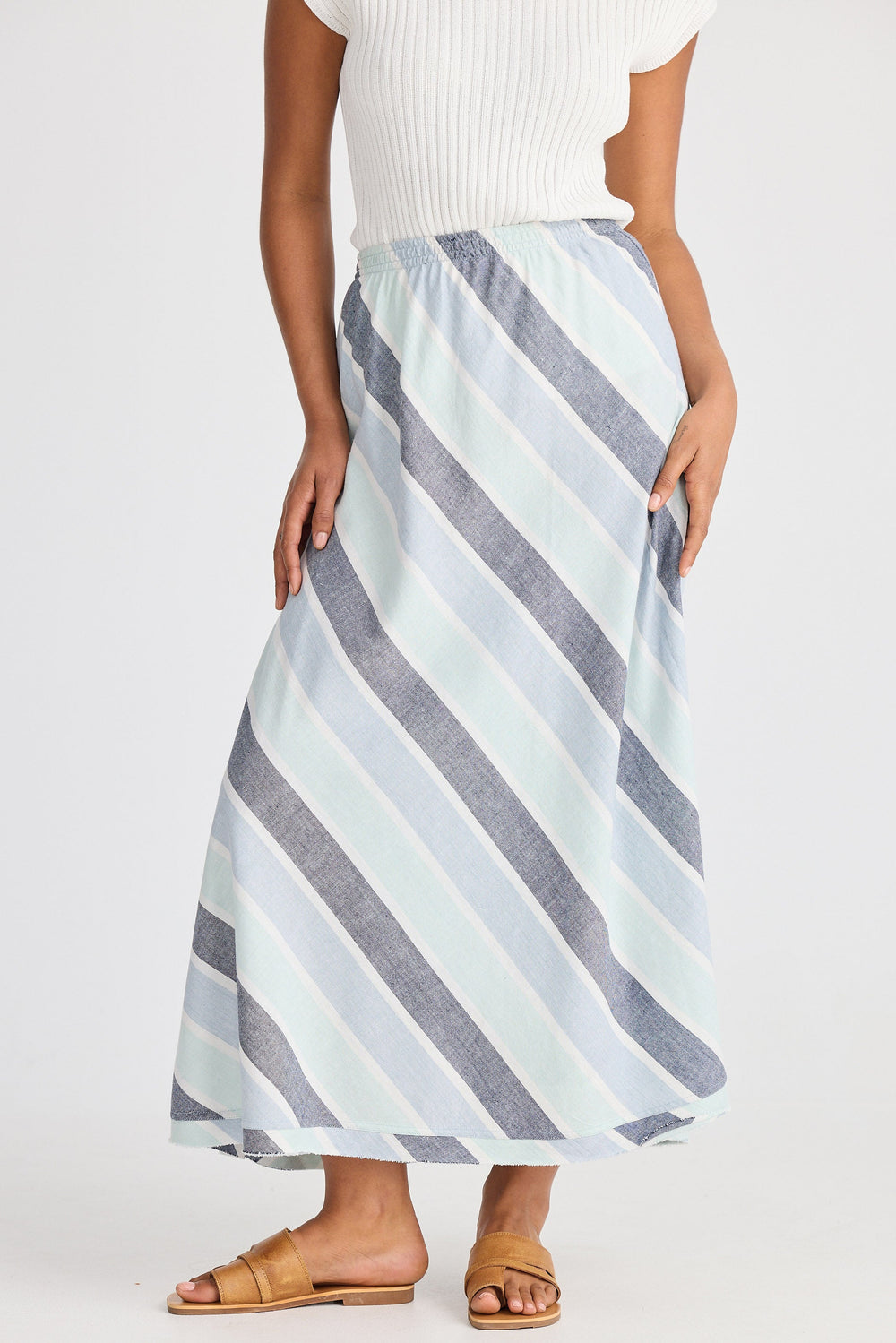 Person wearing a striped skirt on a white background