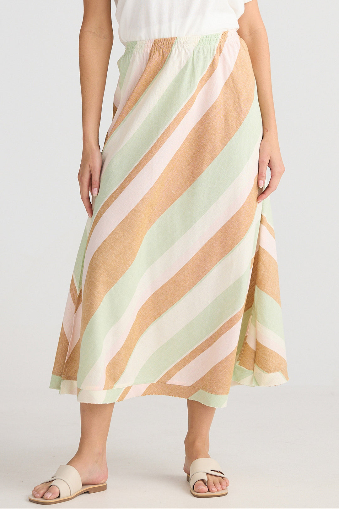 Person wearing a pastel striped skirt on a white background