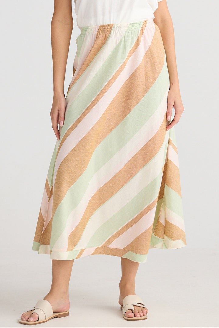 Person wearing a pastel striped skirt on a white background