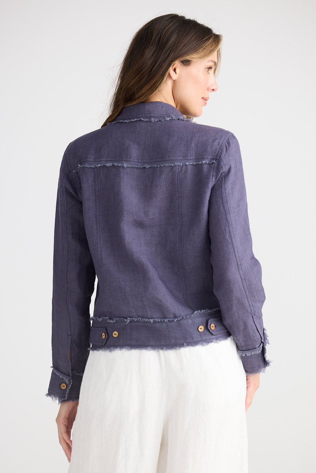 Woman wearing a navy jacket on a white background