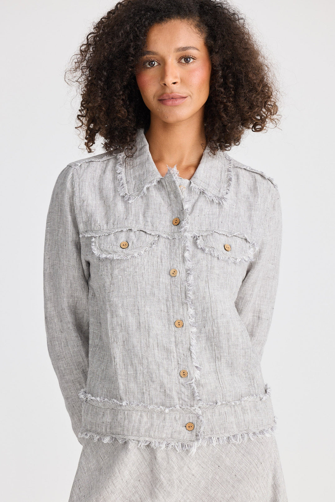Woman wearing a light gray jacket on a white background