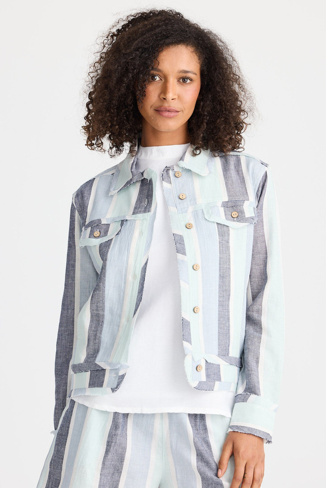 Woman wearing a patterned outfit with a white background