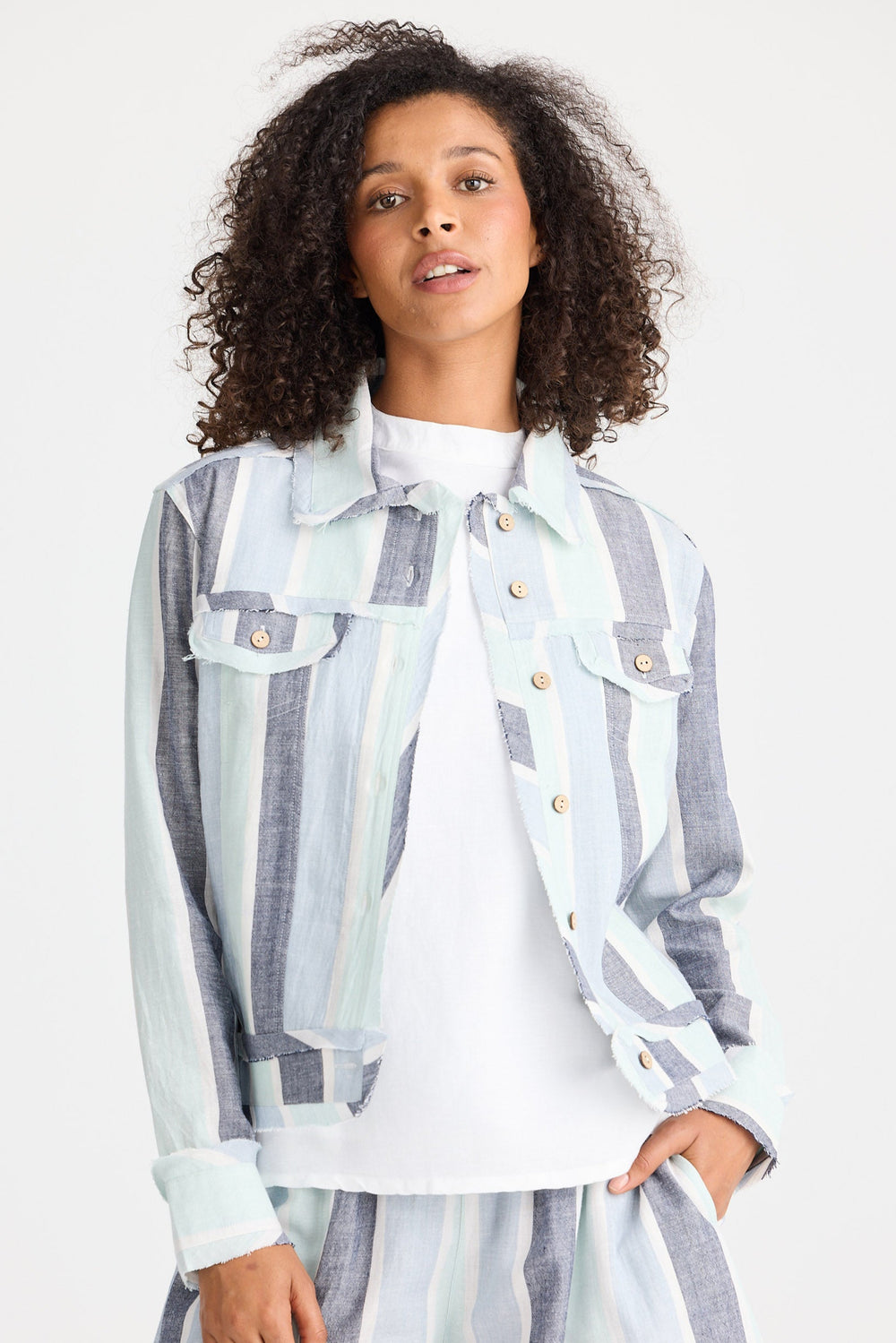 Woman wearing a striped jacket and shorts set on a white background