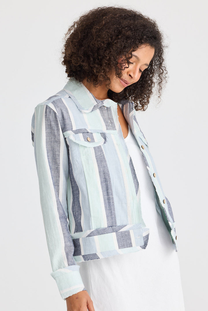 Woman wearing a striped shirt with a jacket on a white background