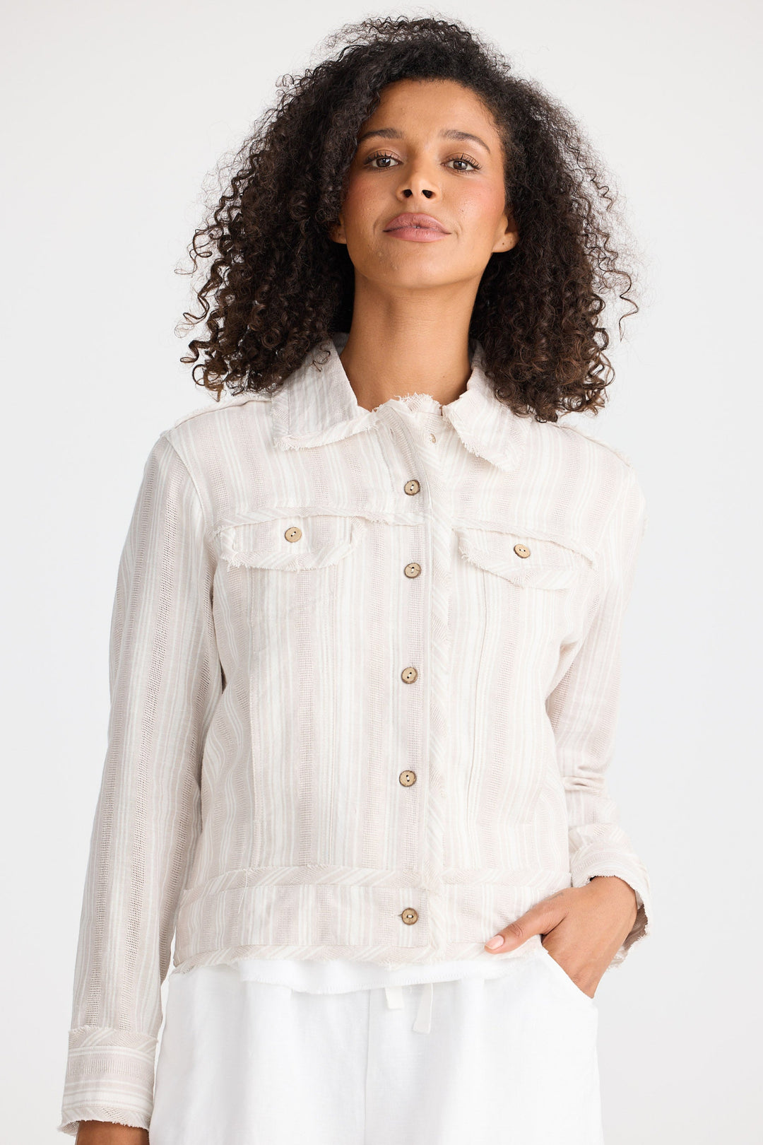 Woman wearing a light-coloured  jacket on a white background