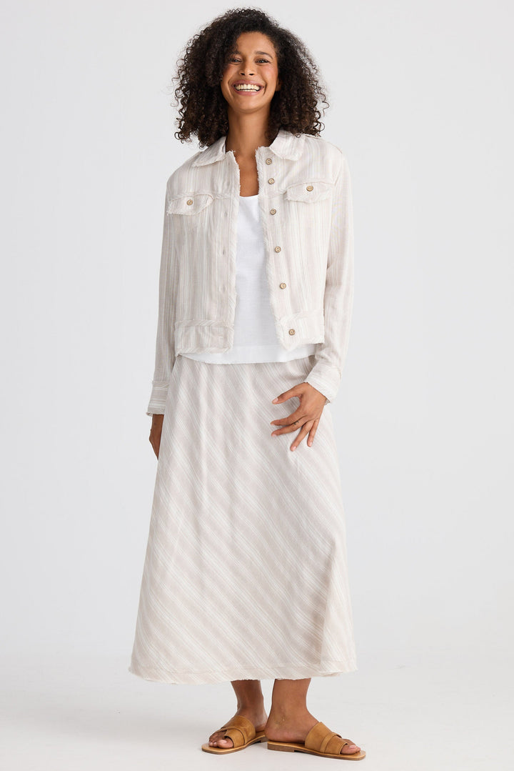 Woman wearing a white top with a light jacket on a white background