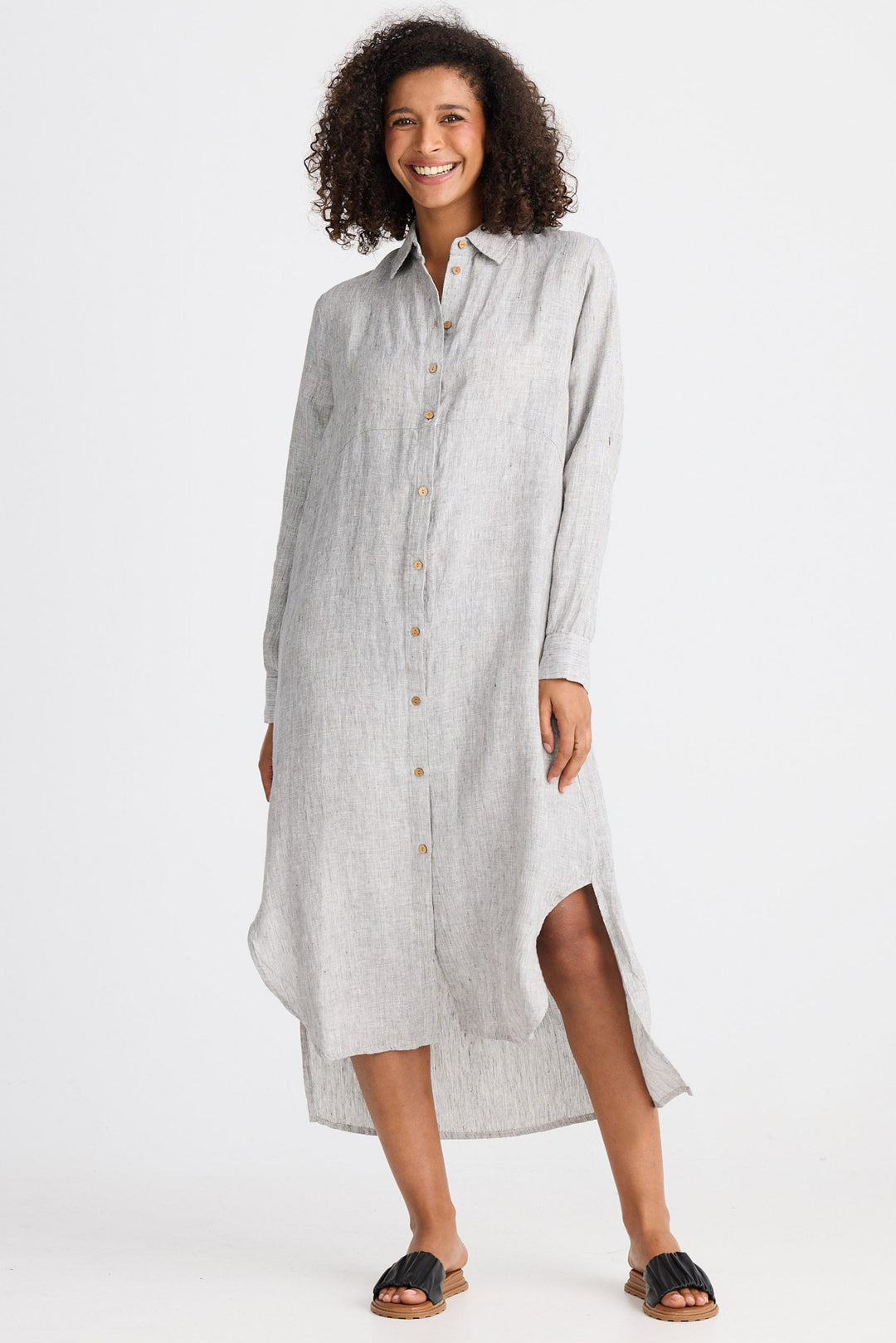Woman wearing a light gray shirt dress on a white background